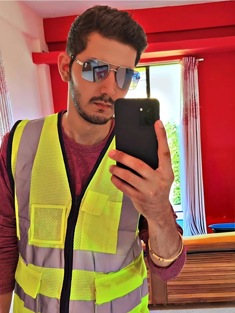 Training-day portrait of Vinay Dambani wearing a high-visibility safety vest